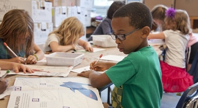 boy wearing eyeglasses studying 640×350 1.jpg
